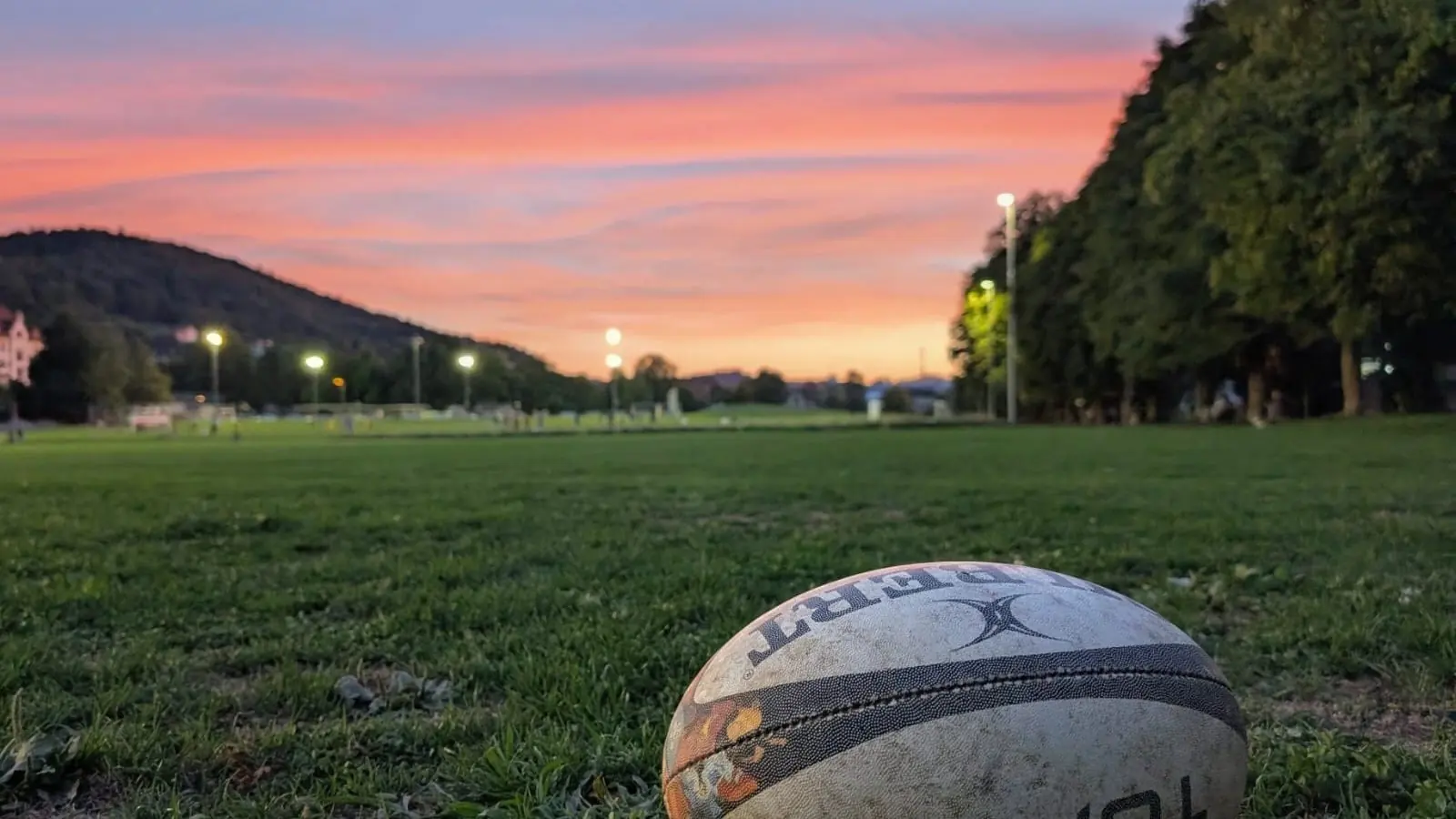 Touch rugby players in action at sunset on the Kreuzbleiche pitch in St. Gallen