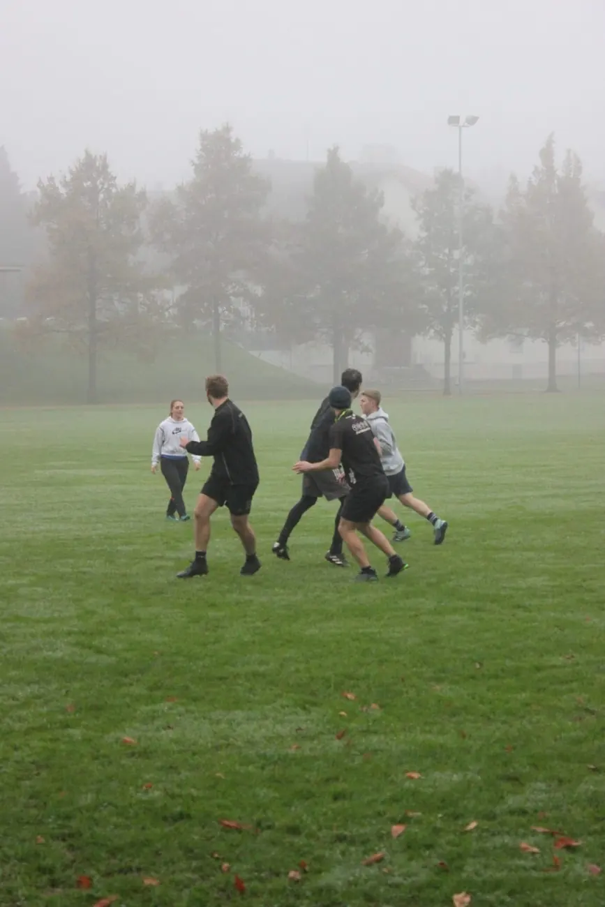 Touch rugby training on a foggy autumn evening in St. Gallen