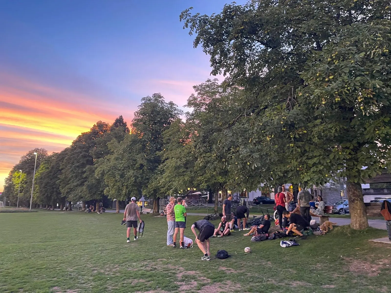Players sitting together on the grass after the final game of the evening