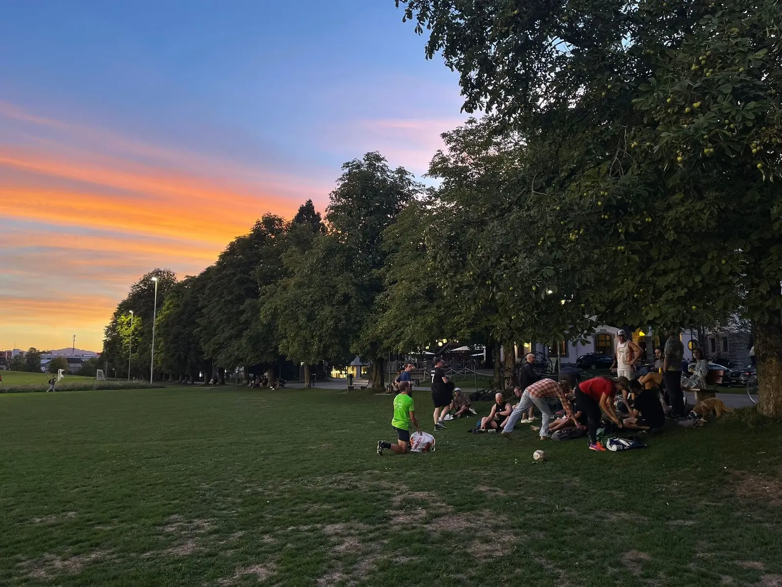Wide view of the Kreuzbleiche at sunset with players on the pitch